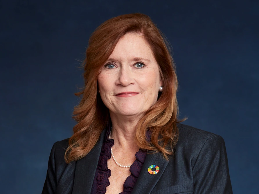 Finished UNFCU leadership portrait with a soft blue background