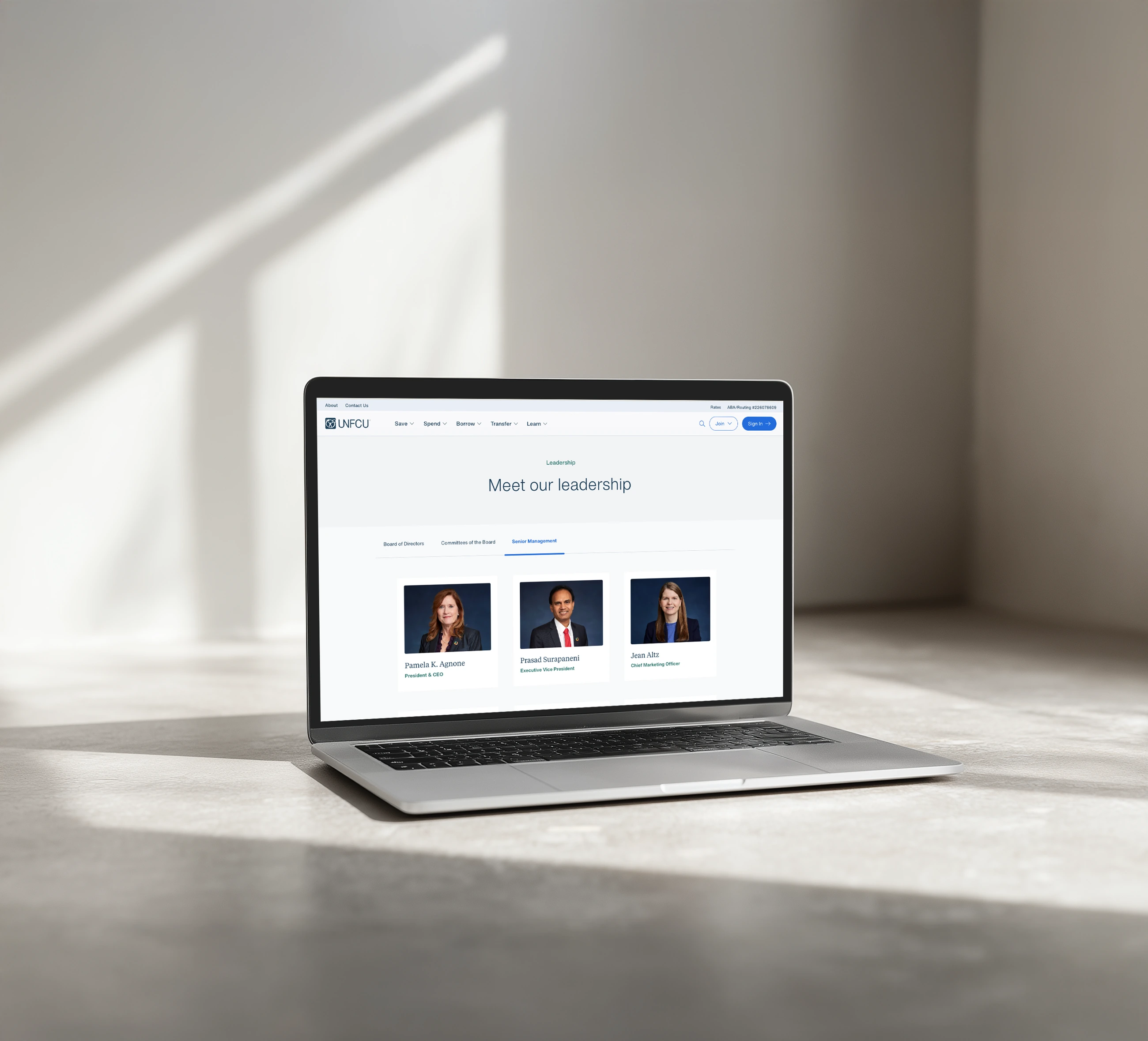 Refreshed UNFCU leadership website with consistent blue portrait backgrounds